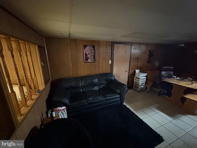 tiled living room featuring wooden walls