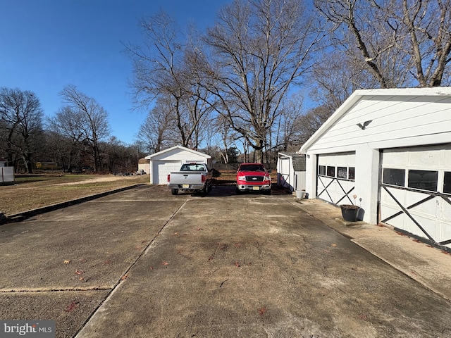 view of side of property with a garage and an outdoor structure