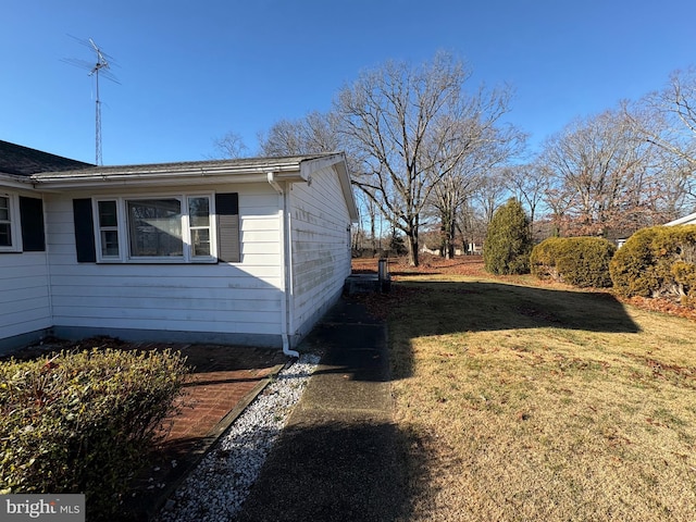 view of side of home featuring a lawn