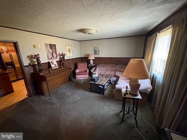 living area featuring a textured ceiling, light carpet, and wood walls