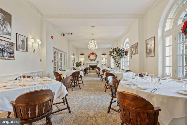 dining space with plenty of natural light and a notable chandelier