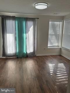 spare room with dark hardwood / wood-style flooring