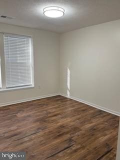 empty room featuring dark hardwood / wood-style flooring