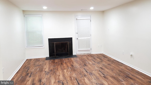 unfurnished living room with dark hardwood / wood-style flooring