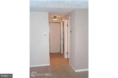 hallway featuring a textured ceiling