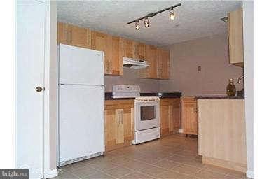 kitchen featuring rail lighting and white appliances