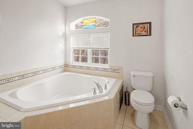 bathroom with toilet, tile patterned flooring, and tiled tub