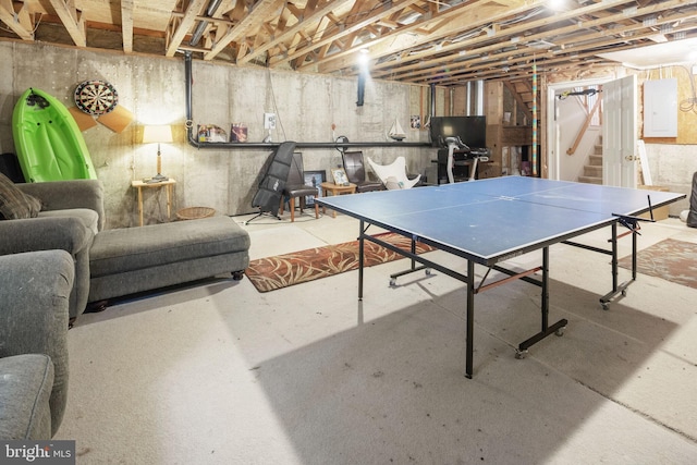 rec room featuring concrete flooring and electric panel