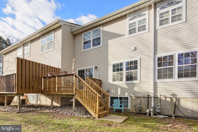 rear view of property with a wooden deck and central AC