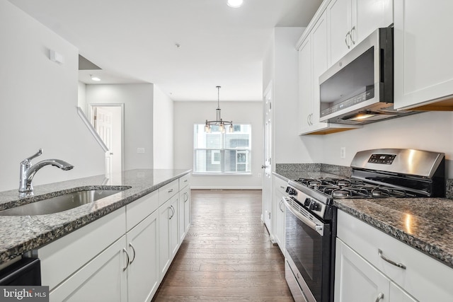 kitchen with white cabinetry, sink, dark stone counters, and appliances with stainless steel finishes