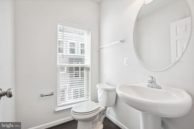 bathroom with plenty of natural light and toilet