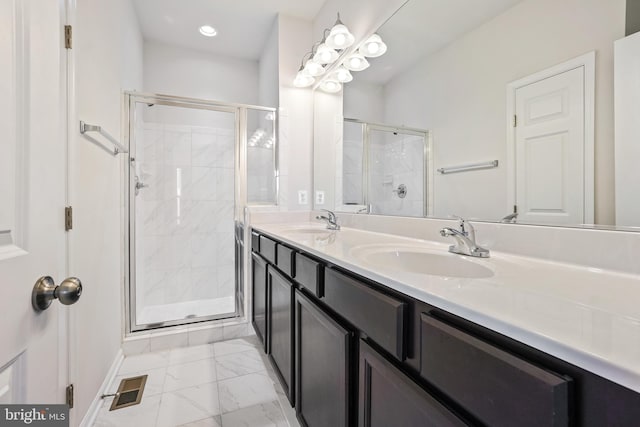 bathroom featuring vanity and a shower with shower door