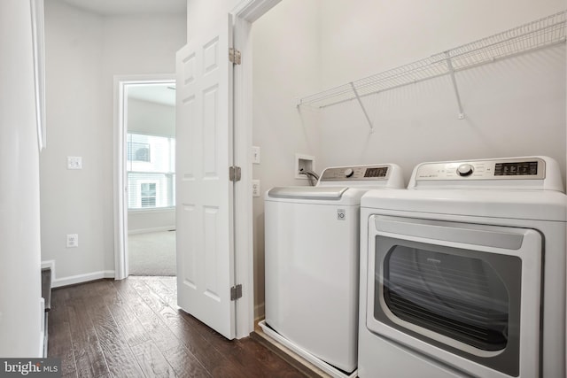 laundry area with dark wood-type flooring and washer and clothes dryer