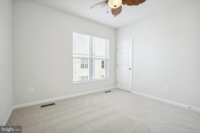 unfurnished room featuring light colored carpet and ceiling fan