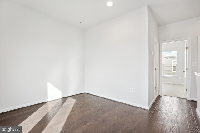 empty room with dark hardwood / wood-style floors