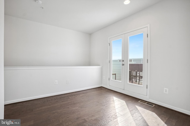 unfurnished room featuring hardwood / wood-style floors and french doors