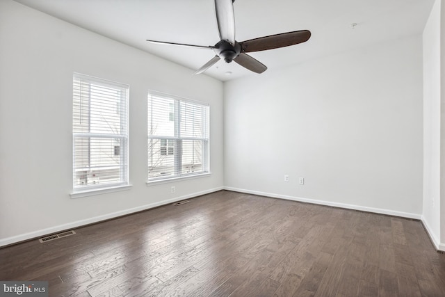 spare room featuring ceiling fan and dark hardwood / wood-style flooring