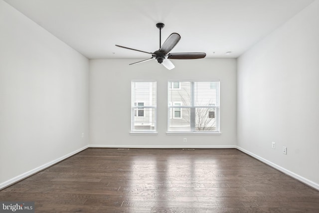 empty room with dark wood-type flooring and ceiling fan