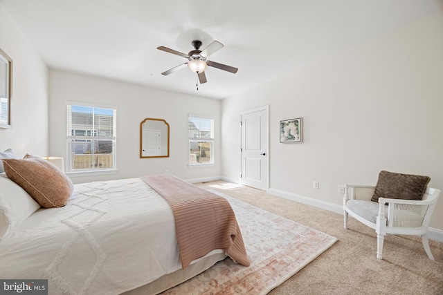 bedroom with carpet, baseboards, and a ceiling fan