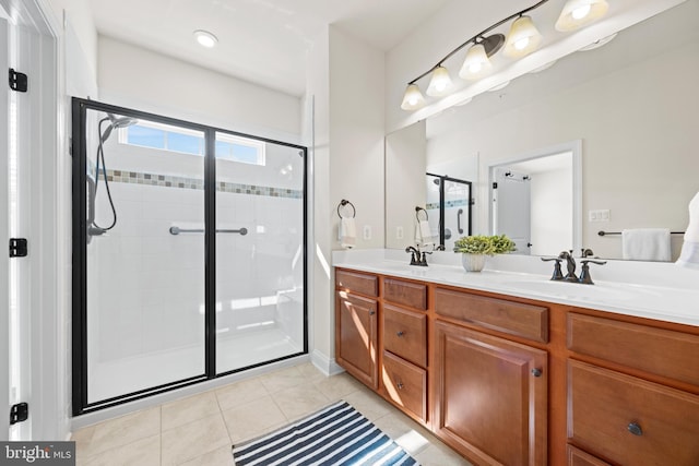 full bathroom featuring tile patterned flooring, a sink, a shower stall, and double vanity