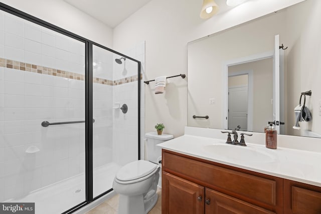 bathroom with vanity, tile patterned flooring, a shower stall, and toilet