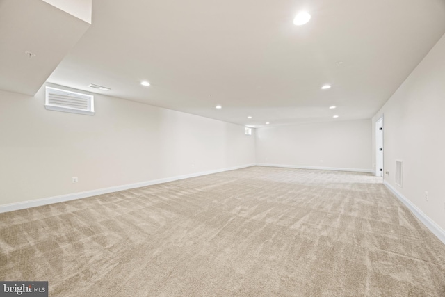 finished basement featuring recessed lighting, baseboards, and light colored carpet