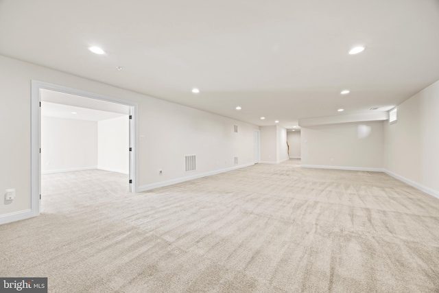 finished basement with recessed lighting, visible vents, baseboards, and light colored carpet