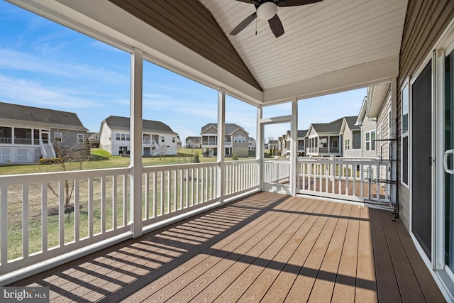 wooden deck featuring a residential view and a ceiling fan