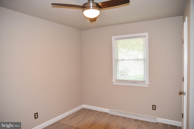 carpeted spare room with ceiling fan and baseboard heating