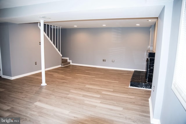 basement with light hardwood / wood-style floors