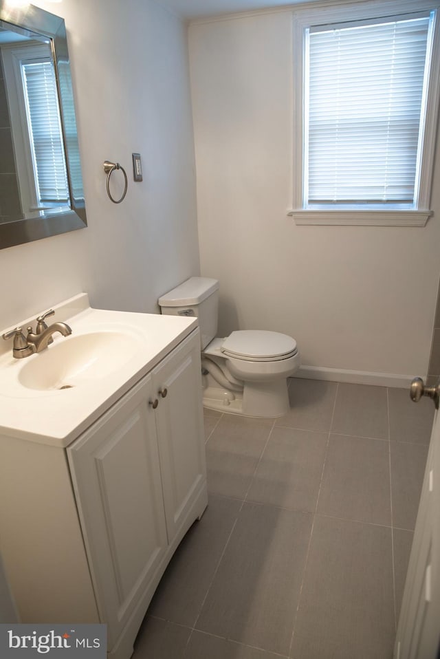 bathroom with tile patterned floors, vanity, and toilet