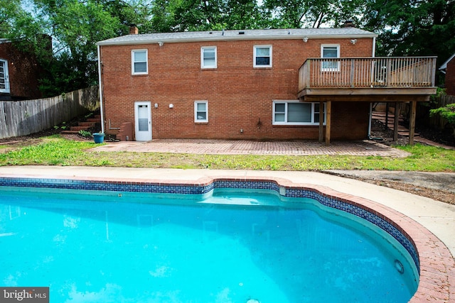 view of swimming pool featuring a deck and a patio area