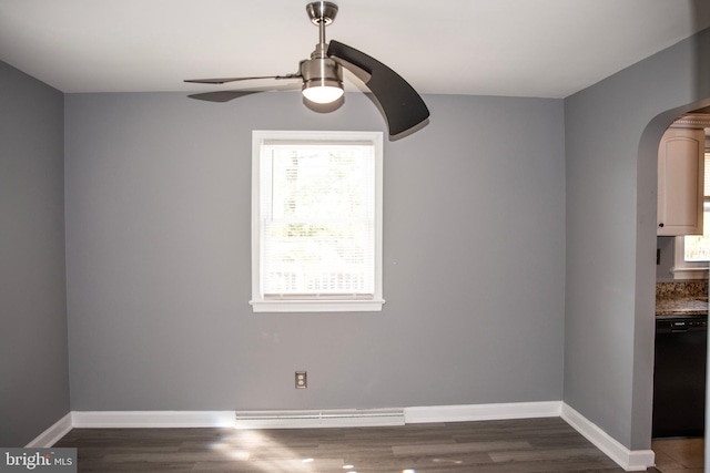 unfurnished dining area featuring ceiling fan, baseboard heating, and dark wood-type flooring