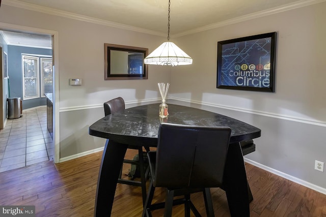 dining area featuring ornamental molding and hardwood / wood-style floors