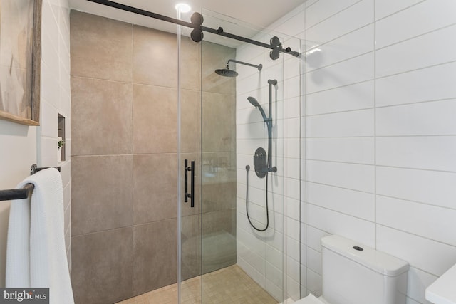 bathroom with toilet and walk in shower