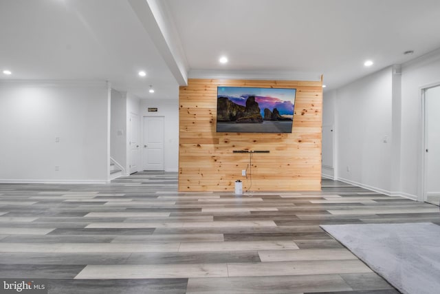 unfurnished living room featuring wooden walls and light wood-type flooring