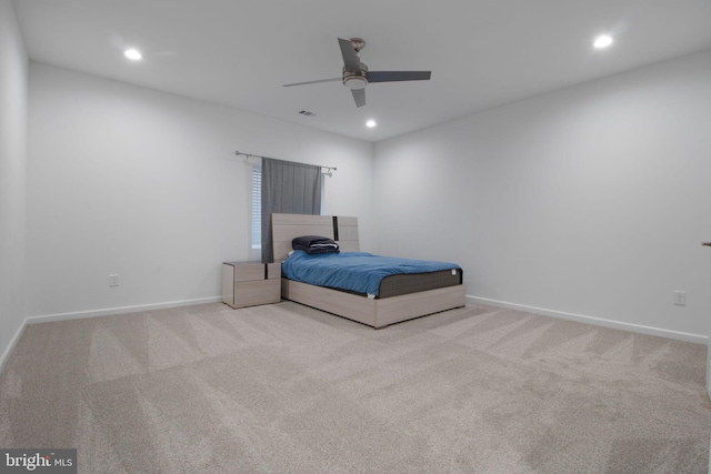 unfurnished bedroom featuring light colored carpet and ceiling fan