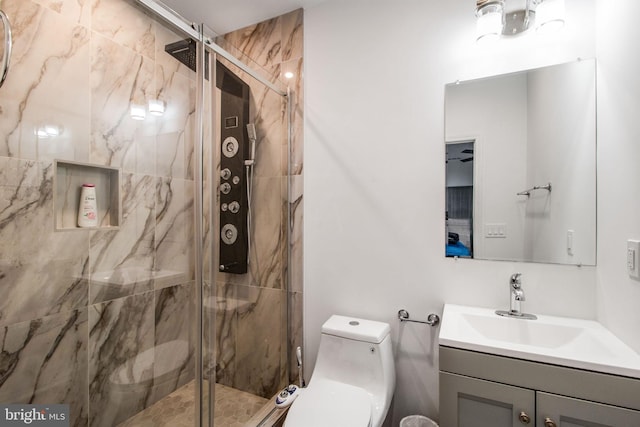 bathroom featuring vanity, walk in shower, and toilet