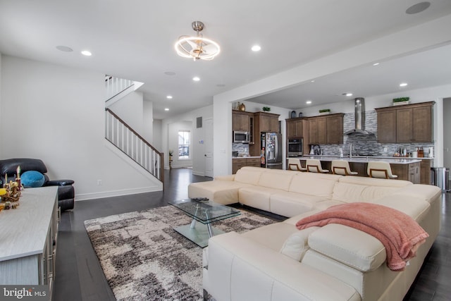 living room with dark hardwood / wood-style floors and sink