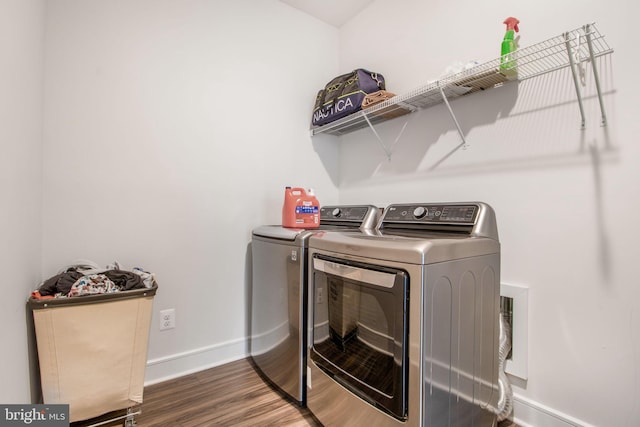 laundry room with dark hardwood / wood-style flooring and independent washer and dryer