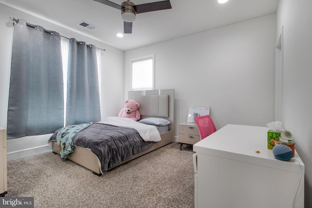 bedroom featuring light carpet and ceiling fan