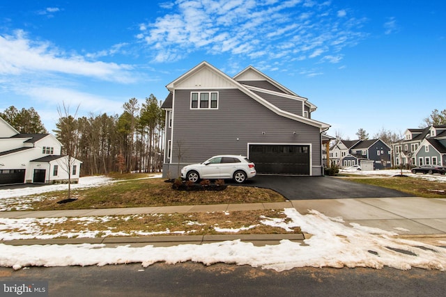 view of snow covered exterior with a garage