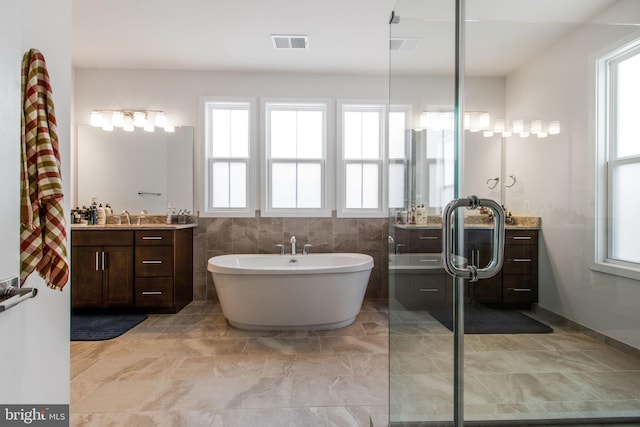 bathroom featuring vanity and a tub to relax in