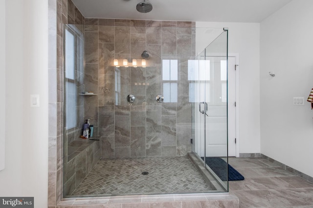 bathroom with a shower with door