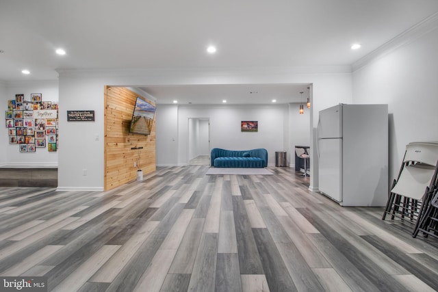 living area with hardwood / wood-style flooring and crown molding