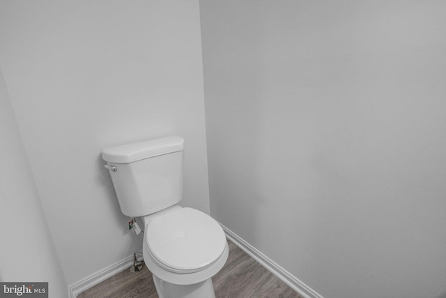 bathroom featuring toilet and wood-type flooring