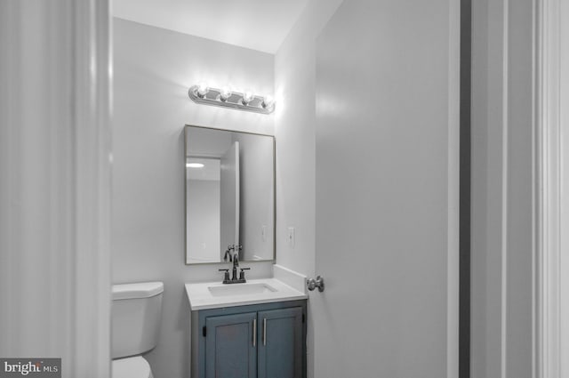 bathroom with toilet and vanity