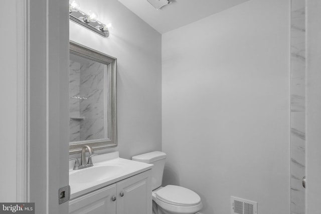 bathroom with toilet and vanity