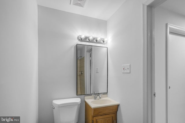 bathroom with toilet and vanity