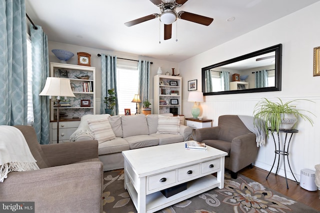 living room featuring dark hardwood / wood-style floors and ceiling fan